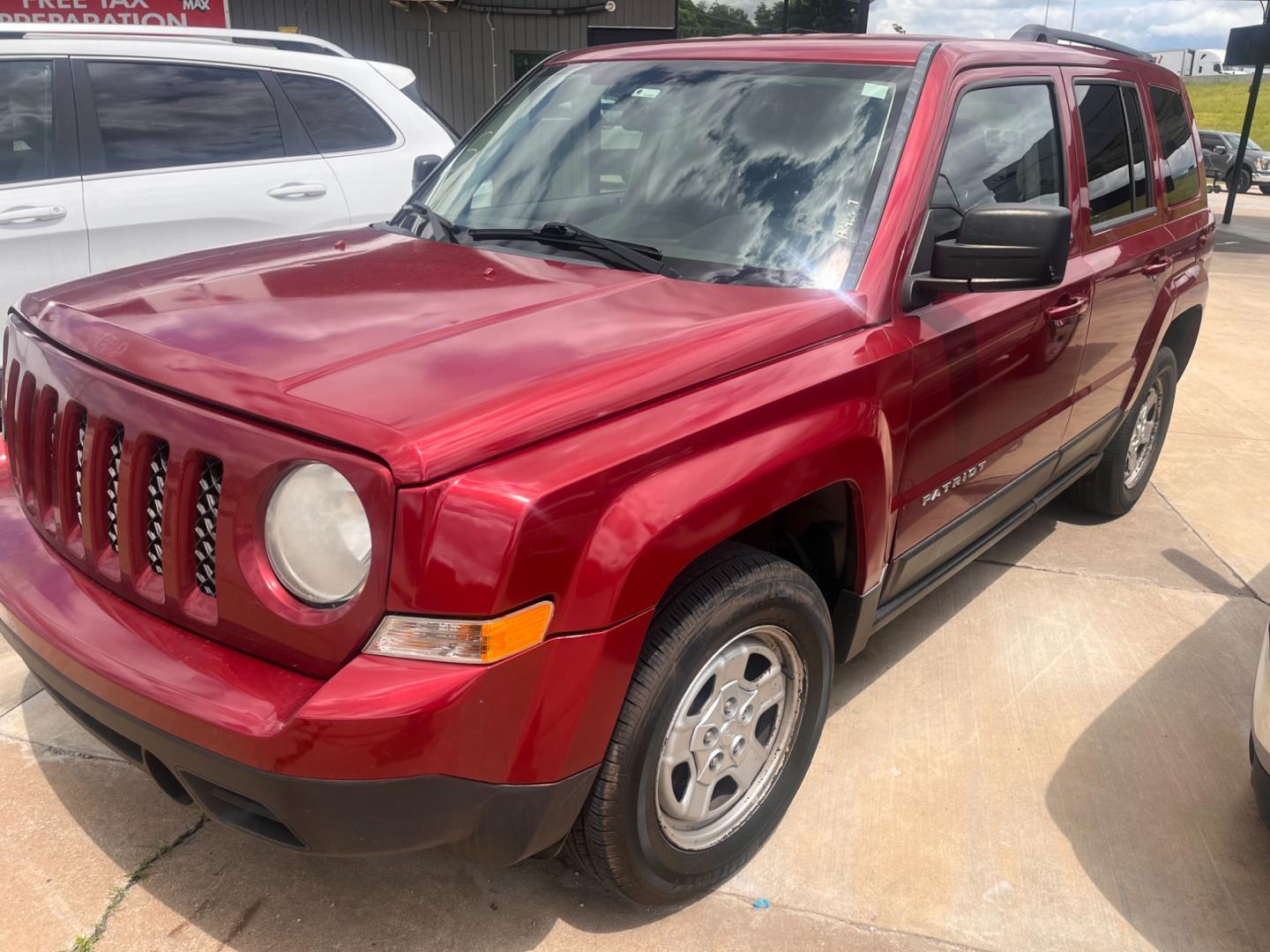 2014 RED Jeep Patriot Sport 4WD (1C4NJRBB9ED) with an 2.4L L4 DOHC 16V engine, located at 8101 E. Skelly Dr., Tulsa, OK, 74129, (918) 592-3593, 36.121891, -95.888802 - Photo#0